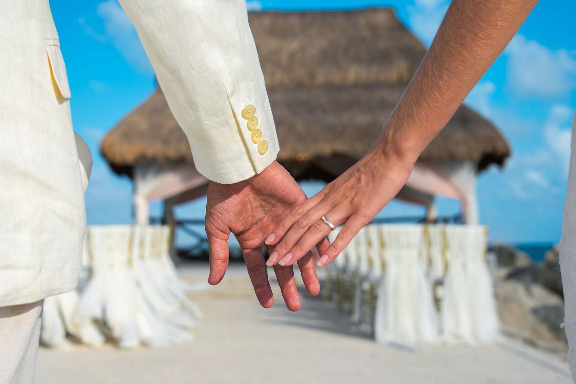 Closeup of a bride and groom holding hands