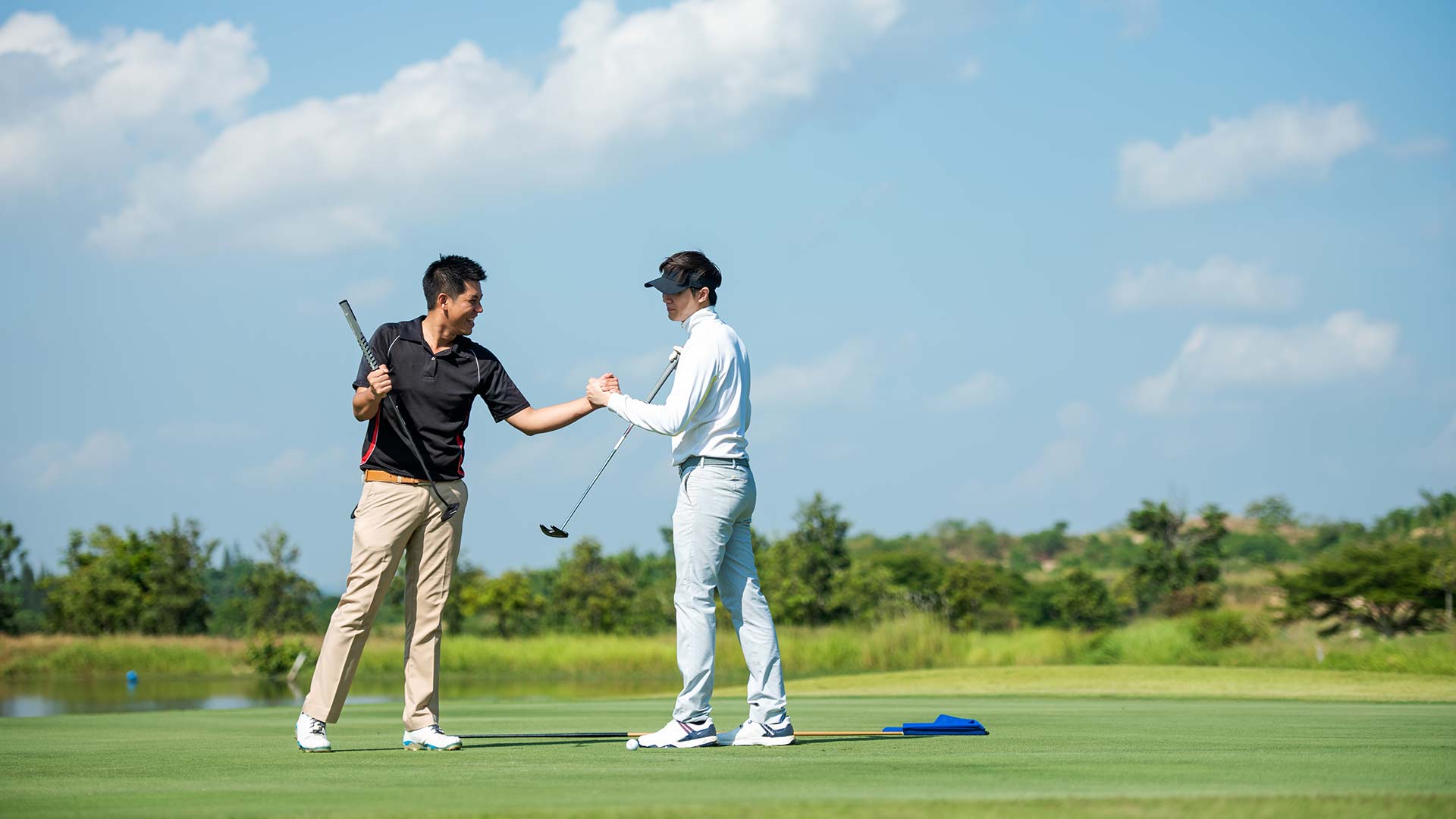 Two golfers shaking hands